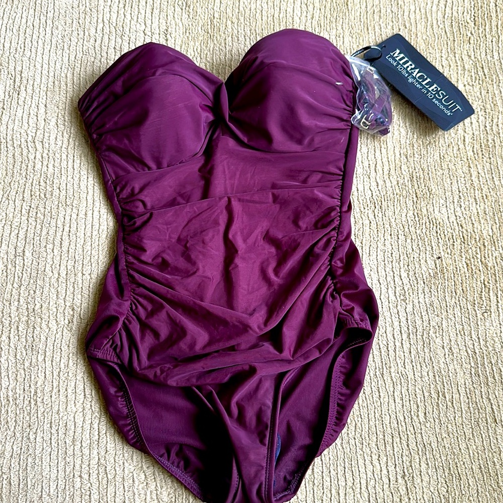 Purple strapless (comes with straps) one piece bathing suit.